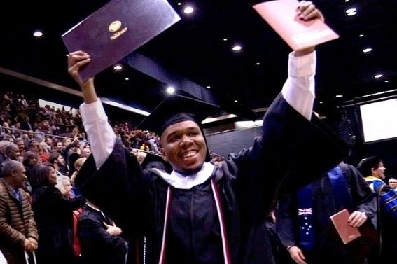 student in regalia during commencement