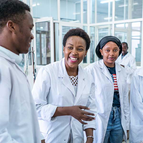 Researchers smiling in lab coats