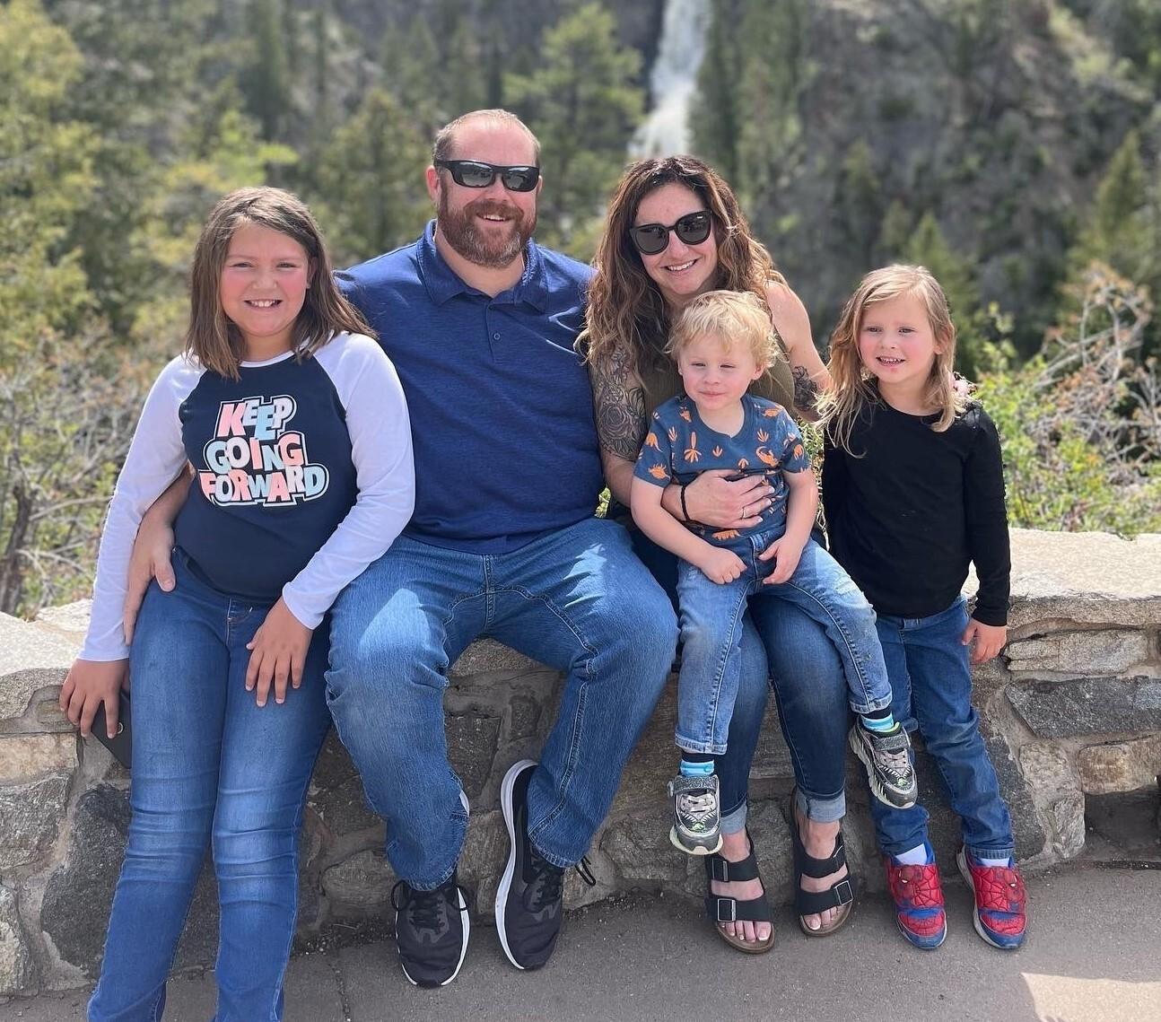 A group shot of Mackenzie Merrick and her family outdoors.