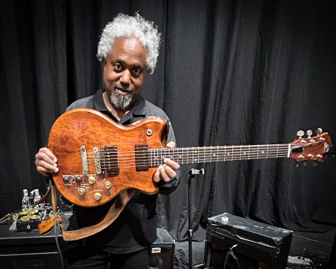 Pat Metheny's guitar tech, Andre Cholmondeley pictured at the Barbican Hall, London, on November 15, 2025, holding Metheny's Roland GR-303 Guitar Controller.