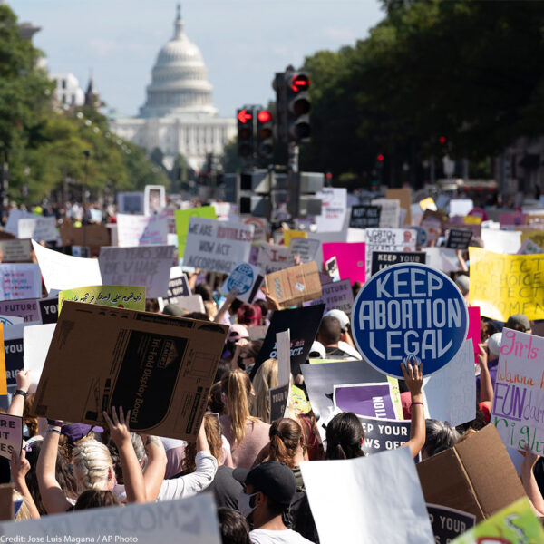 With the U.S Capitol in the back ground thousands of demonstrators march on Pennsylvania Avenue during the Women's March in Washington, Saturday, Oct. 2, 2021.