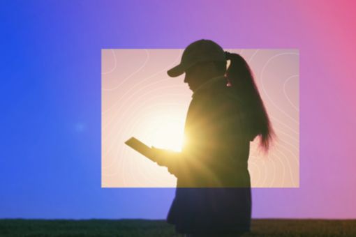 Image of girl on a tablet in a field