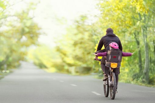 Family riding bicycleon 