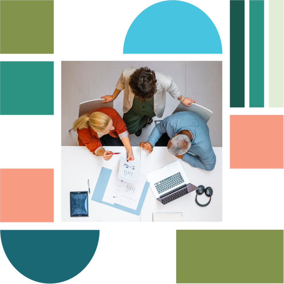 A bird's eye view of people sitting and working around a desk