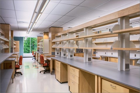 A long hallway lined on each side with a tabletop and many drawers and shelves.