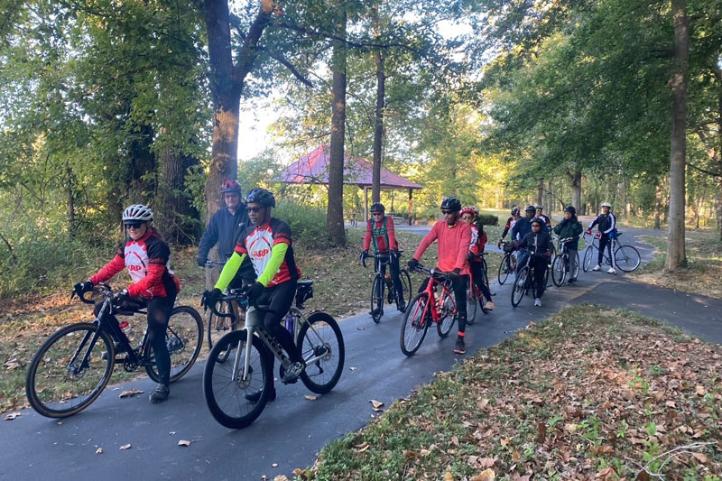 A group of cyclist riding on a trail