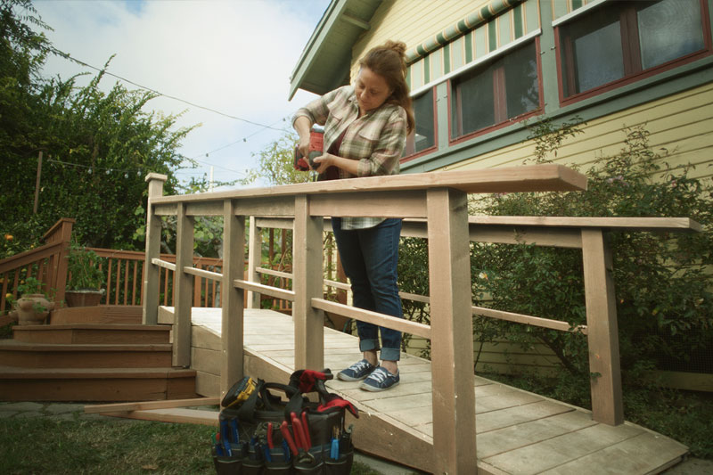 A women building a ramp for accessibility