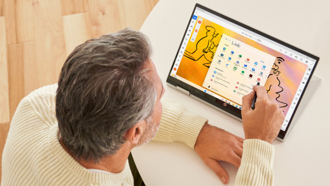 A man using a digital pen with his PC