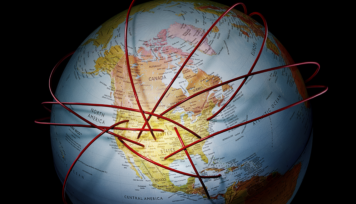 photo of a globe showing north america with thick three dimensional cords punching into it from places unseen around the globe