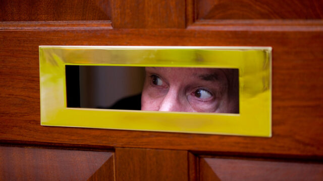 Man looks through letter flap