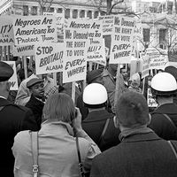 African Americans demonstrating for voting rights in front of the White House as police and others watch, March 12, 1965. One sign reads, "We demand the right to vote everywhere." Voting Rights Act, civil rights.