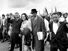 Martin Luther King Jr., and his wife, Coretta, lead off the final lap to the state capitol at Montgomery, Alabama on March 25, 1965. Thousands of civil rights marchers joined in the walk, which began in Selma, demanding voter registration rights