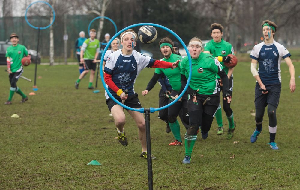 The Keele Squirrels (in green) play the Radcliffe Chimeras during the Crumpet Cup quidditch tournament on Clapham Common on February 18, 2017 in London, England. Quidditch is the fictional game played by Hogwarts students in J.K. Rowling's Harry Potter novels. In 2005 two college students in Vermont created "Muggle Quidditch" to be played on a field for non-magical participants. The sport took off and is now played by hundreds of teams across the world with a global cup competition every two years. True to the original game two teams of seven players sitting astride "broomsticks." Each team has to advance the quaffle ball to one of three opposing hoops against bludgers who knock out the players. The game is won when the snitch (a tennis ball in a sock) is caught and whoever has the most points wins. (games)