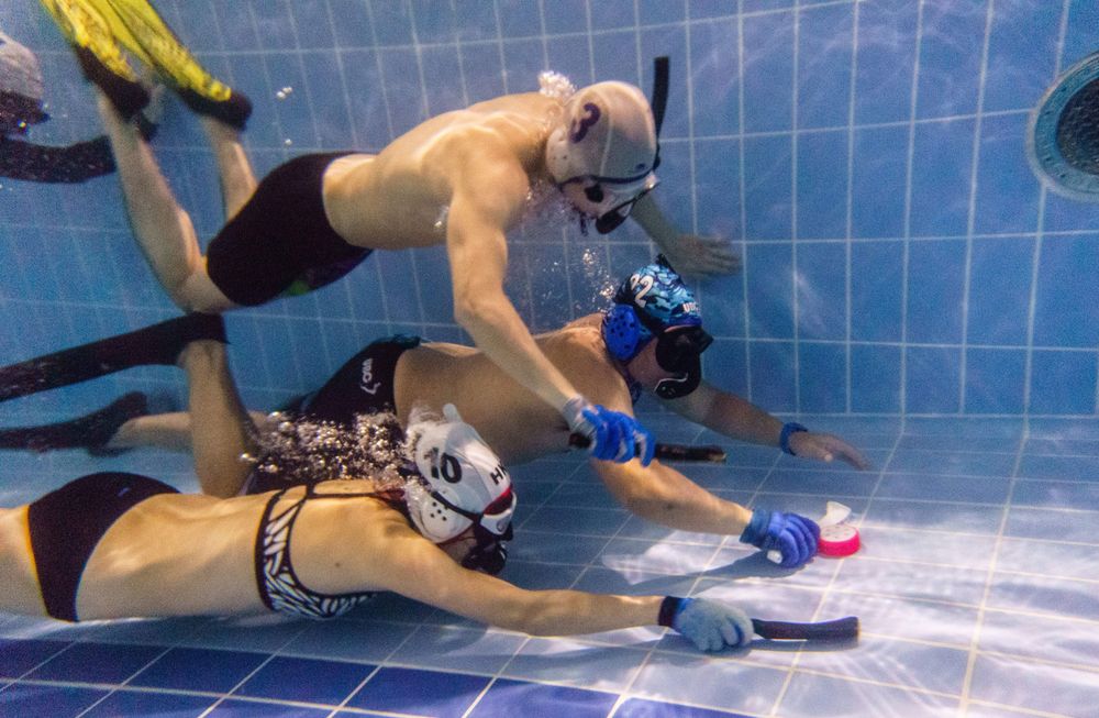 In this photo taken on February 15, 2017, members of the "HK Typhoon" underwater hockey club fight for possession of the puck (right), during their once-a-week team practice session at a 25-meter school pool in Hong Kong. The gravity defying sport of underwater hockey has gained a worldwide following -  now a Hong Kong team is diving in as the game takes off in Asia. (games)