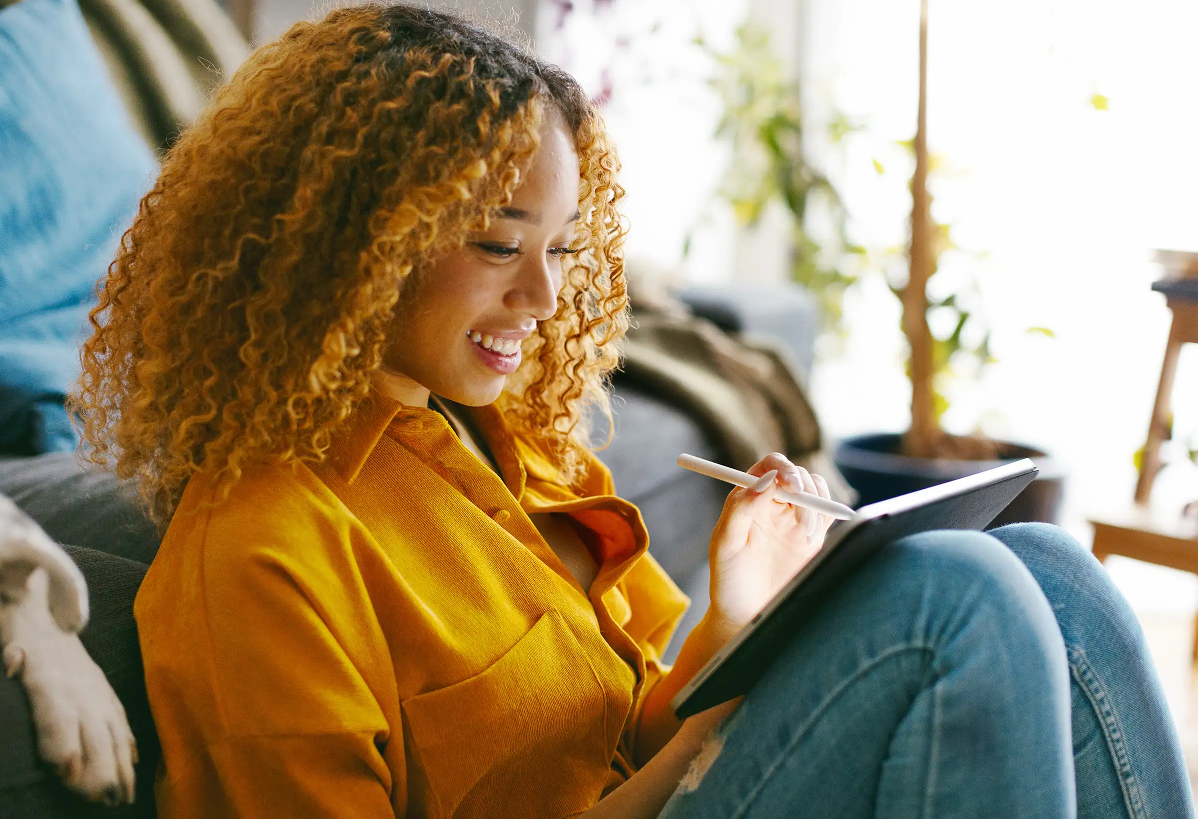 A woman using an iPad with Apple Pencil.