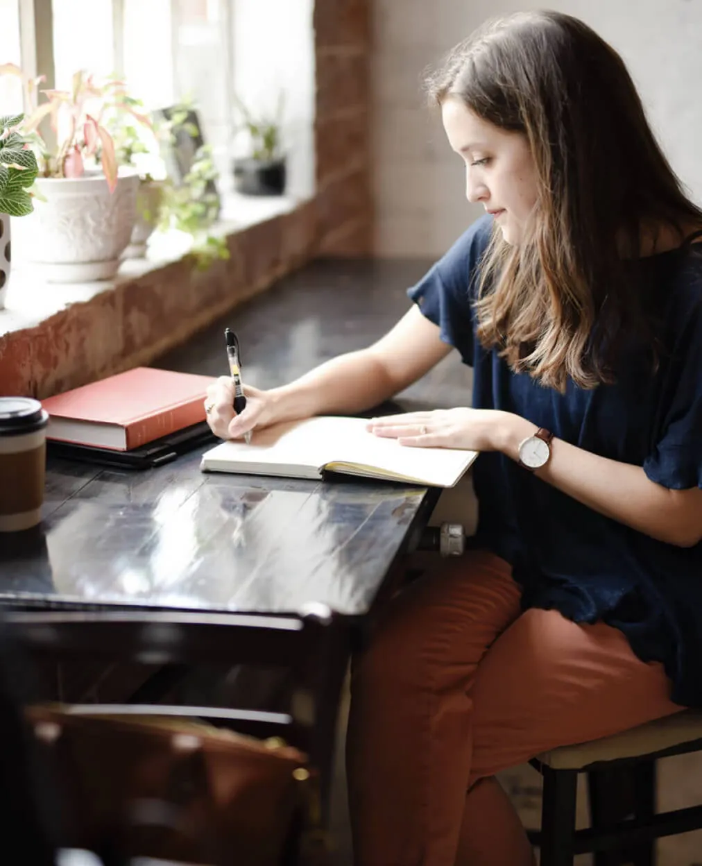 a lady sitting and writing notes