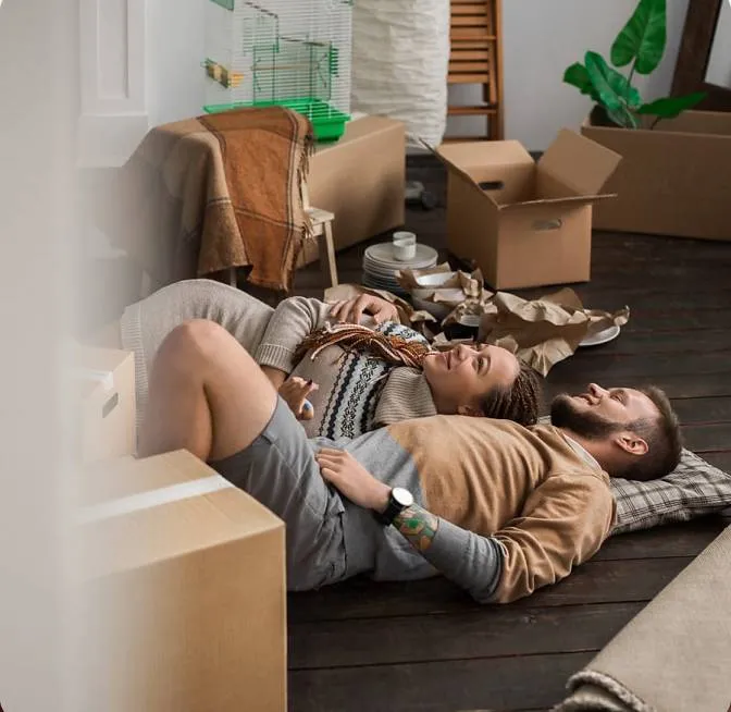 A couple of people laying on top of a wooden floor