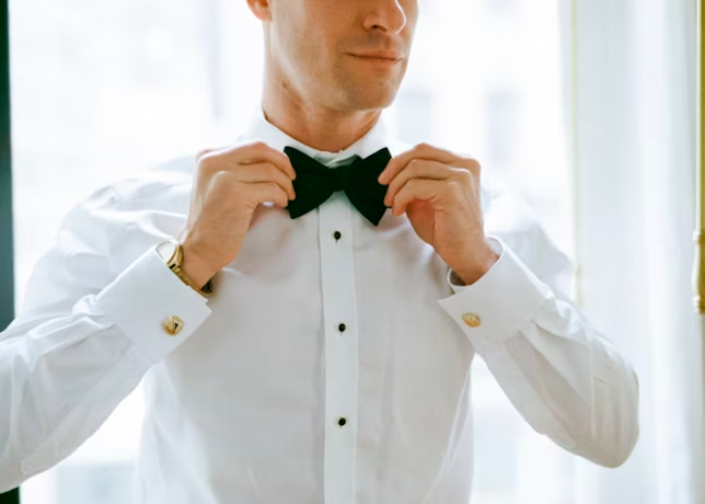 man fixing his bowtie