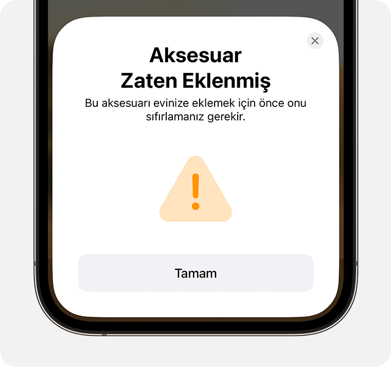 iPhone'da, "Bu aksesuarı evinize eklemek için önce sıfırlamanız gerekir" yönergesini içeren Aksesuar Zaten Eklenmiş iletisi görünüyor