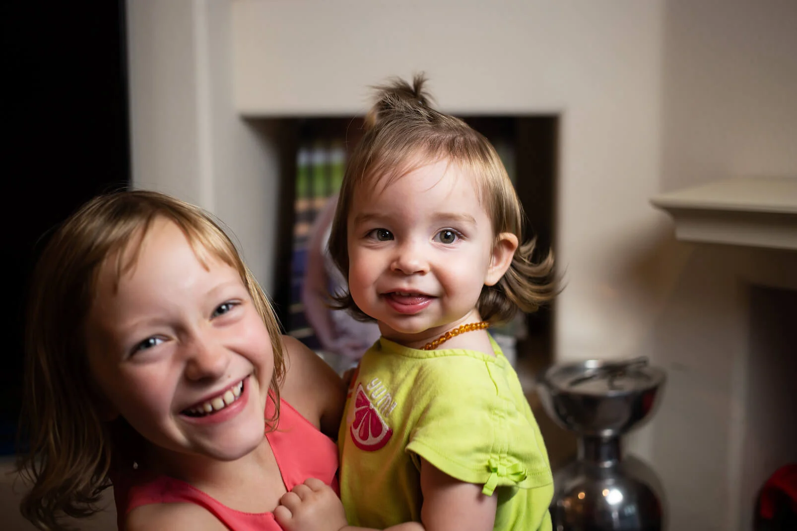 Two sisters laughing and smiling.