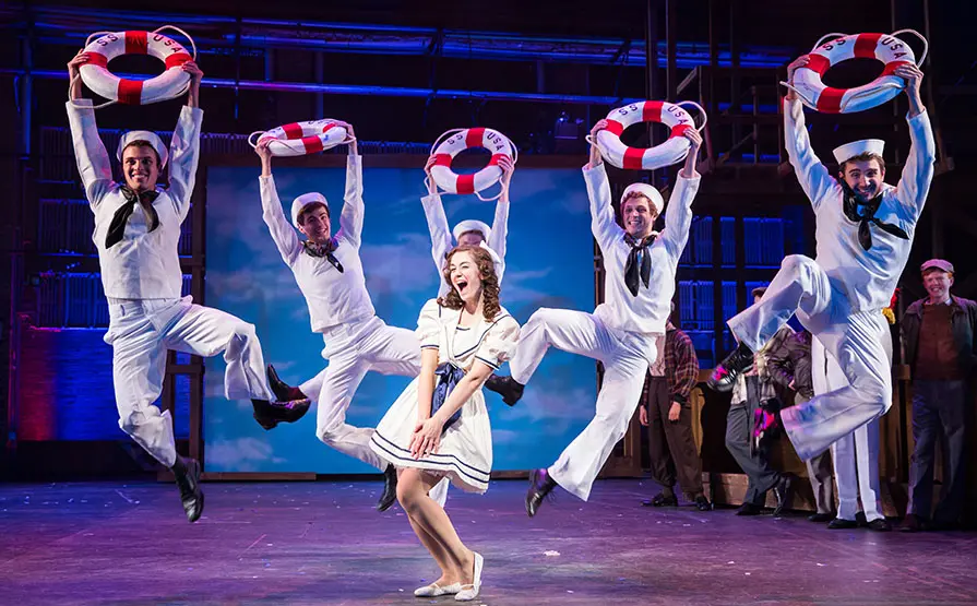 group of students dancing in sailor suits