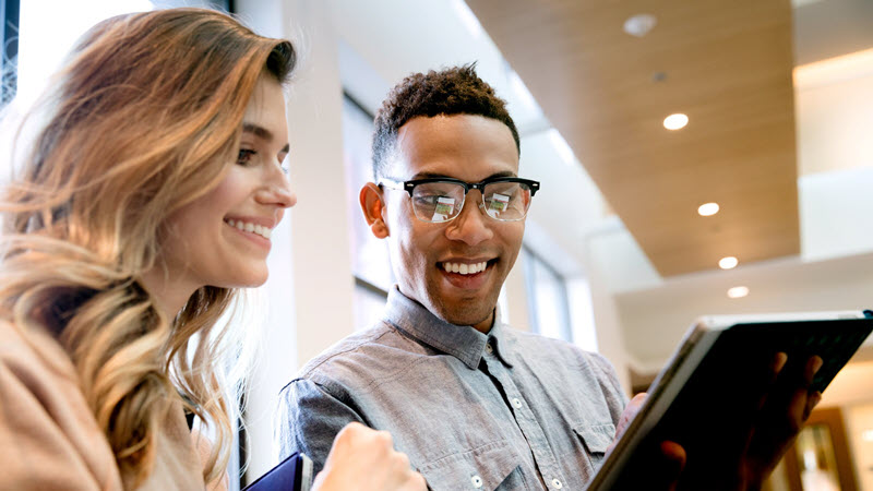 Two information workers looking at a tablet