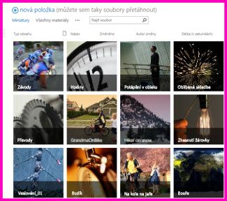Snímek obrazovky knihovny materiálů v SharePointu Zobrazuje miniatury několika videí a obrázků, které knihovna obsahuje. Zobrazuje také standardní sloupce metadat pro multimediální prostředky.