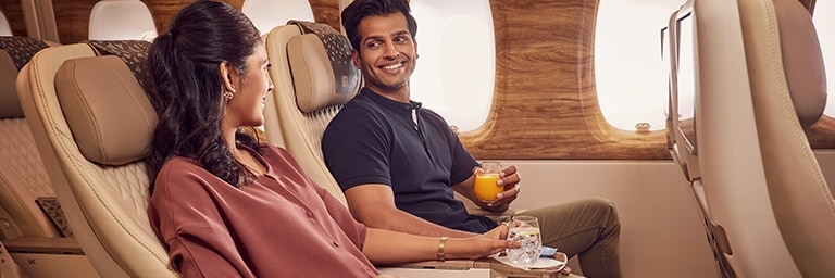 couple enjoying drinks at Emirates Premium Economy