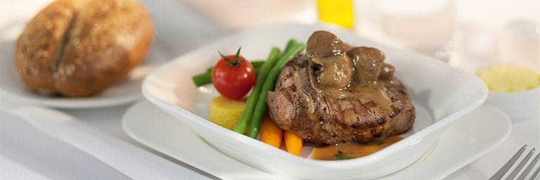 steak and vegetables in Emirates Business Class