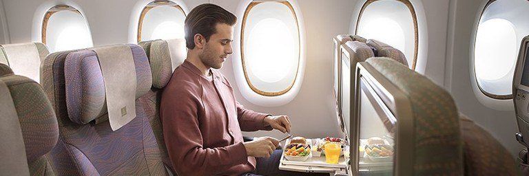 man enjoying meal in economy class