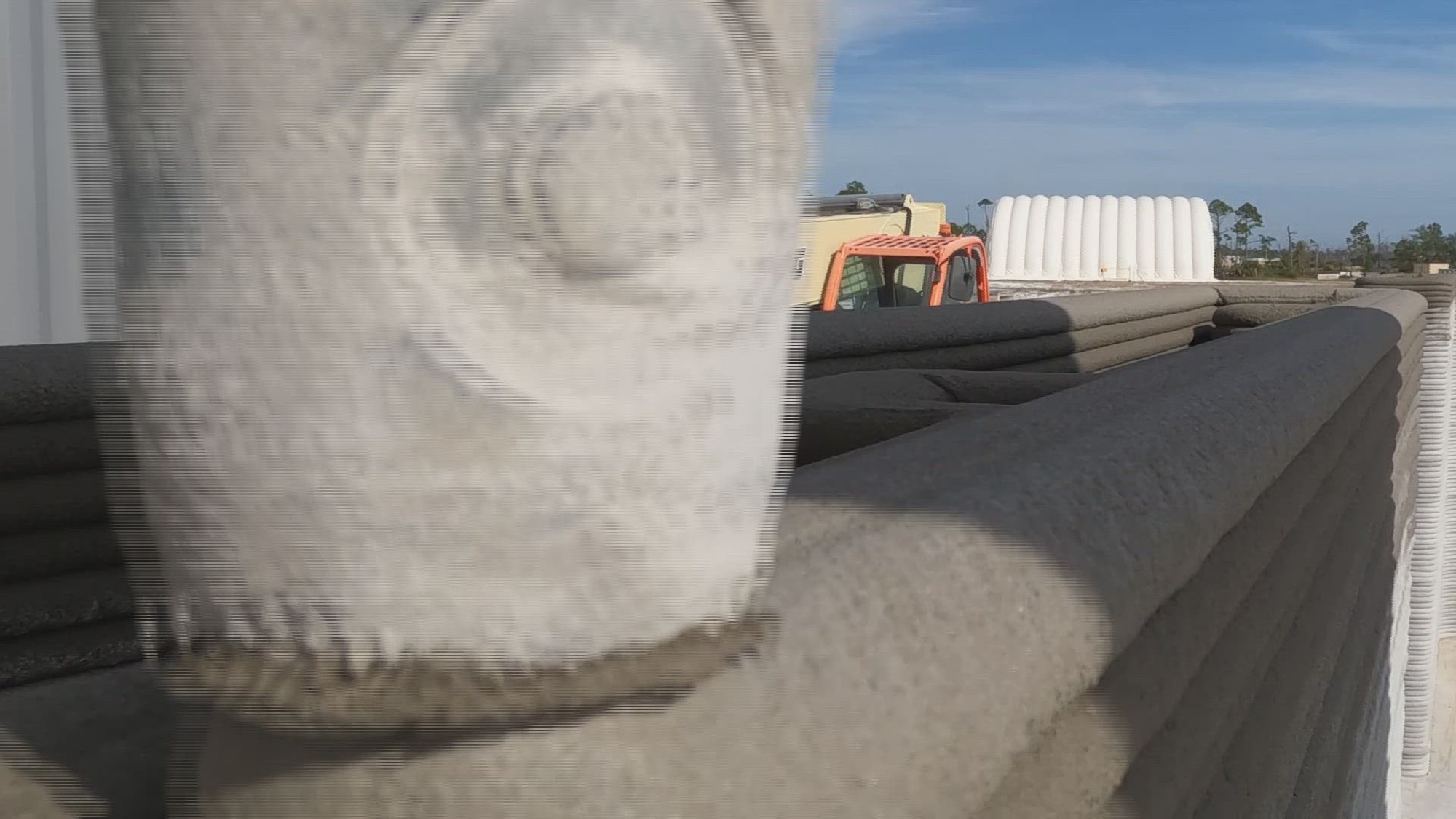 A 3D printer creates a concrete wall.