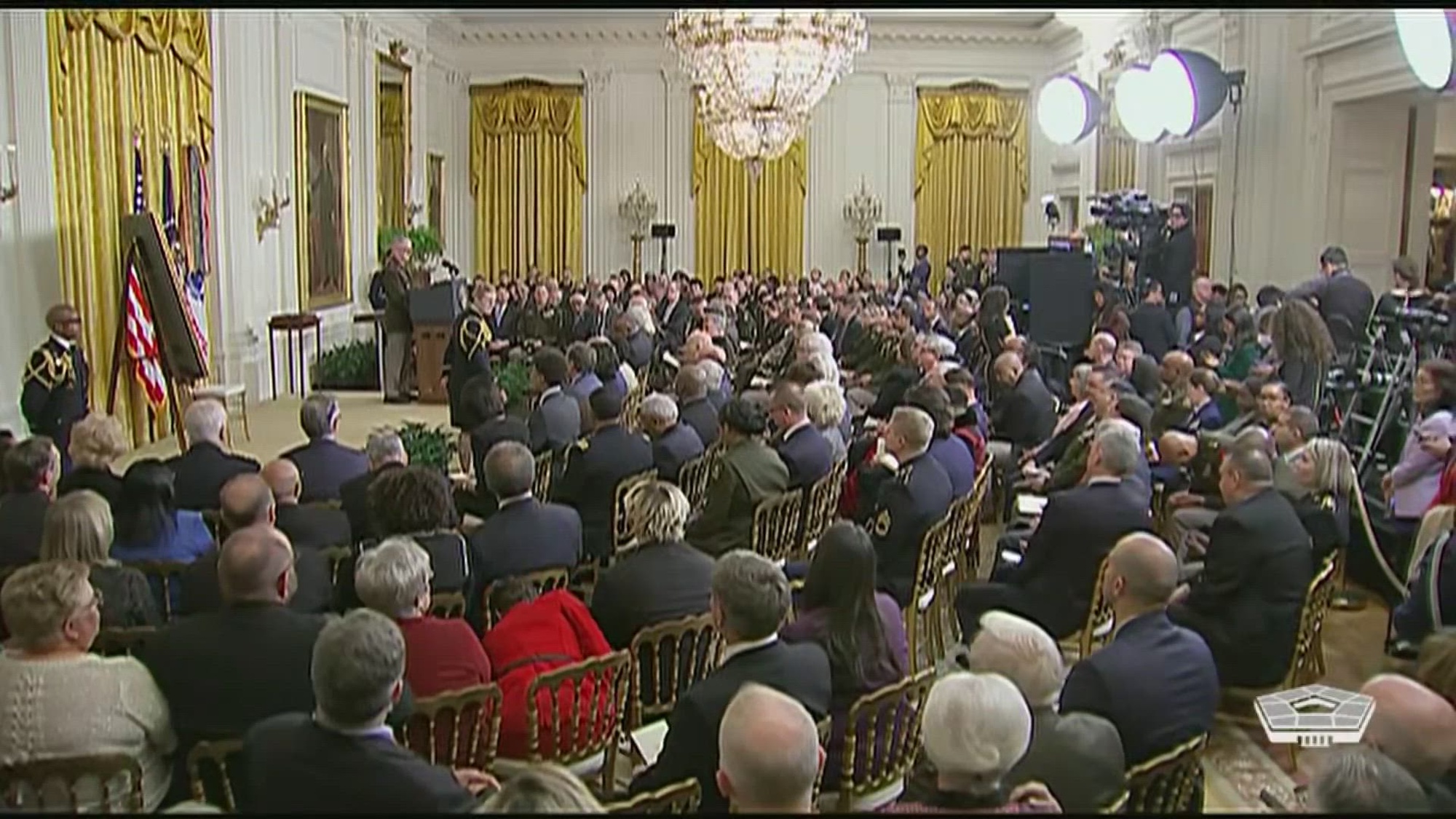 View of a room with a seated audience.