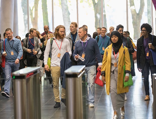 A crowd of people entering venue