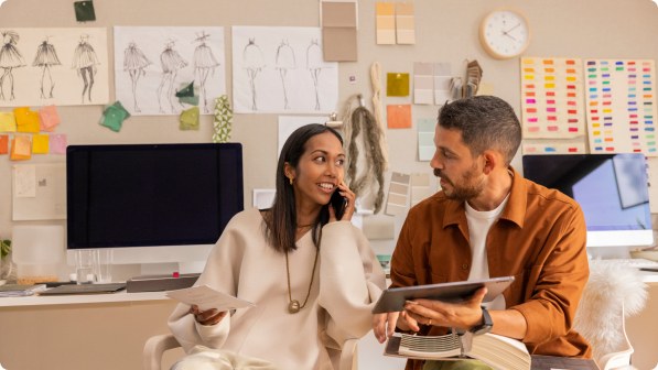 two people in office discussing with a tablet