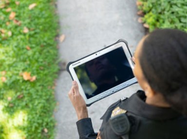 Bird's eye view of a female police officer using a rugged device