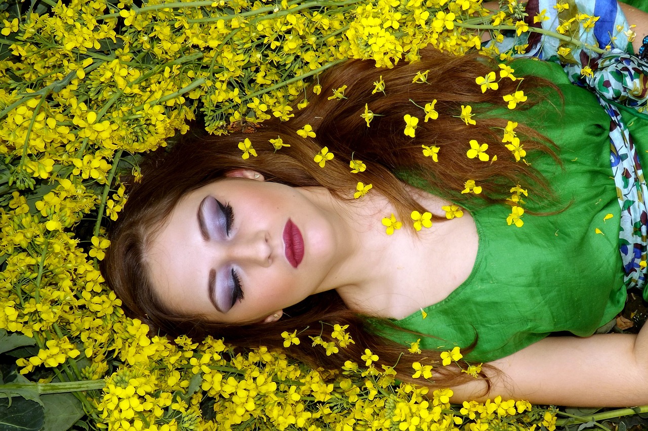 Woman dreaming in field of flowers