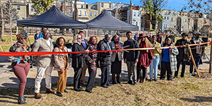 Government and nonprofit officials and community members cut the ribbon on the Etting Street Green Space. Photo by Joe Zimmermann/DNR