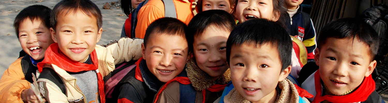 Smiling young Chinese children who've just been let out of school gather on a road in the small Sichuan Province, China village of Li An. © Lei Xu | Dreamstime Images