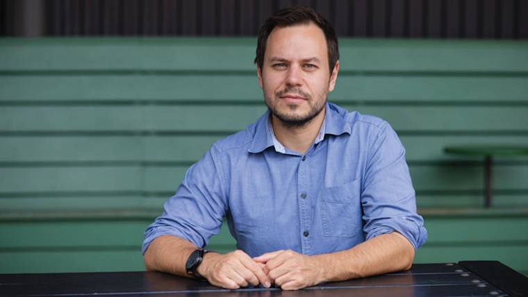 A photograph of Krešimir Končić in a blue shirt sitting at a table.