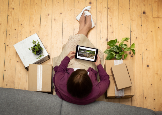 top angle photo of woman stillon the floor working on her laptop