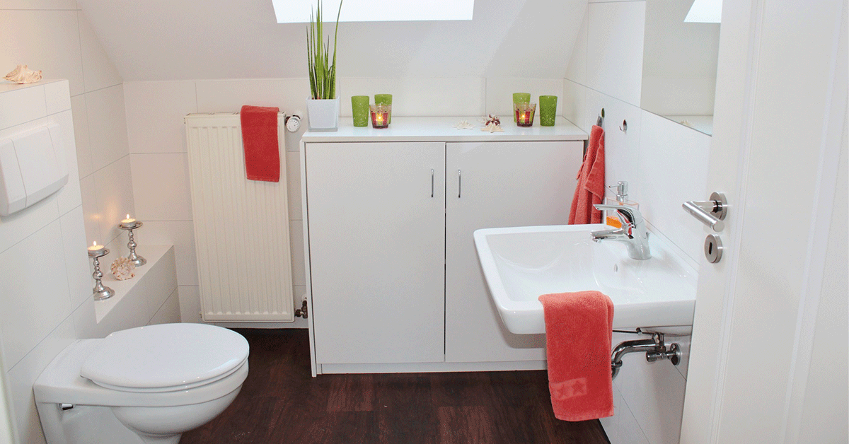 A nice, clean home bathroom with sink, toilet, and a counter.