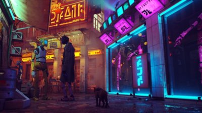 Stray screenshot showing a cat walking through a neon-lit street