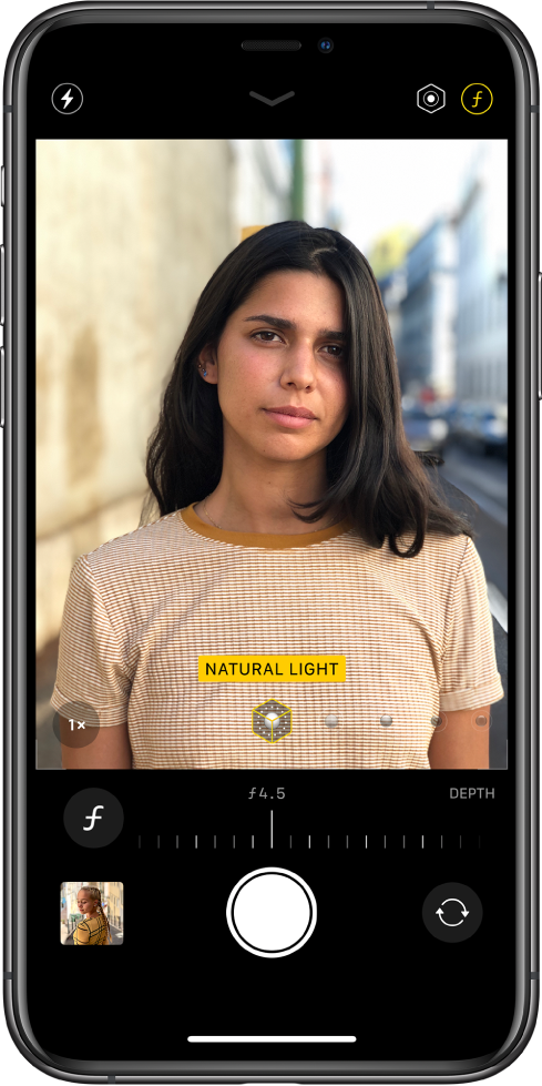 The Camera screen in Portrait mode. The Depth Adjustment button in the top-right corner of the screen is selected. In the camera viewer, a box shows that the Portrait Lighting option is set to Natural Light, and there’s a slider to change the lighting option. Below the camera viewer, there is a slider to adjust the Depth Control.