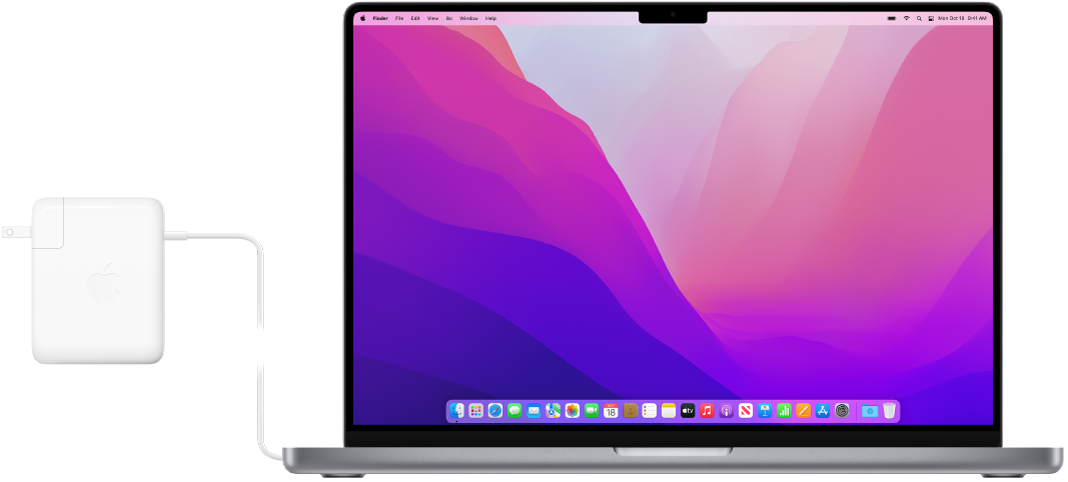 Güç adaptörü bağlı olan bir 16 inç MacBook Pro.