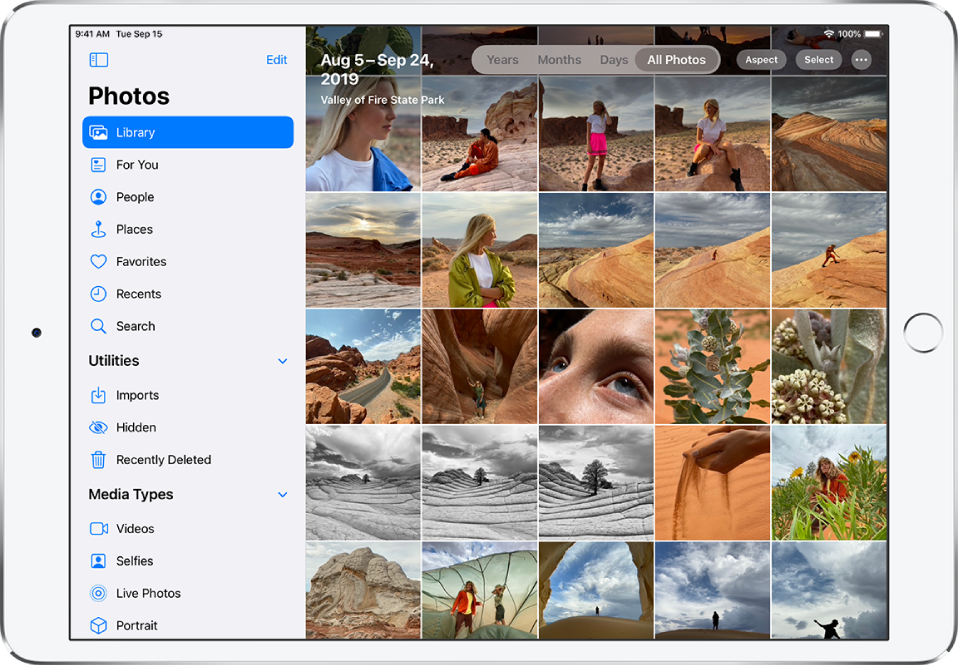 Na levi strani zaslona v aplikaciji Photos je stranska vrstica, v kateri lahko izberete Library, For You, People, Places in druge kategorije. Izbrana je možnost Library. Preostanek zaslona prikazuje knjižnico fotografij v pogledu All Photos. V zgornjem delu knjižnice fotografij sta prikazana datum in lokacija zajetja fotografij. Na sredini zgoraj so možnosti za ogled fotografij po kategorijah Years, Months, Days ter All Photos. Izbrana je kategorija All Photos. V zgornjem desnem kotu zaslona so gumbi Aspect, Select in More.