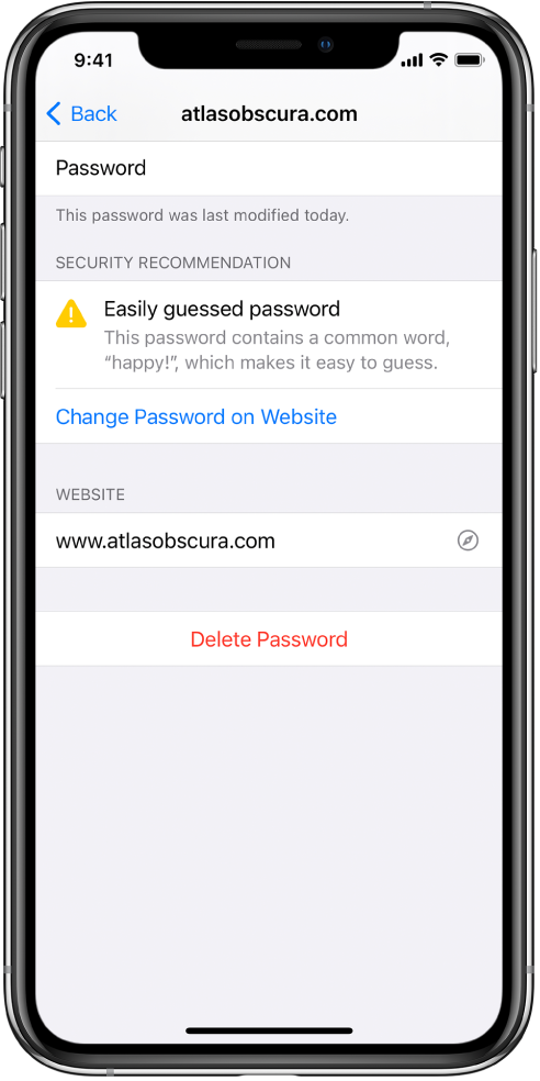 An account screen in Passwords settings. A security recommendation reads “Easily guessed password. This password contains a common word, ‘happy!,’ which makes it easy to guess.” The button Change Password on Website appears below the security recommendation.