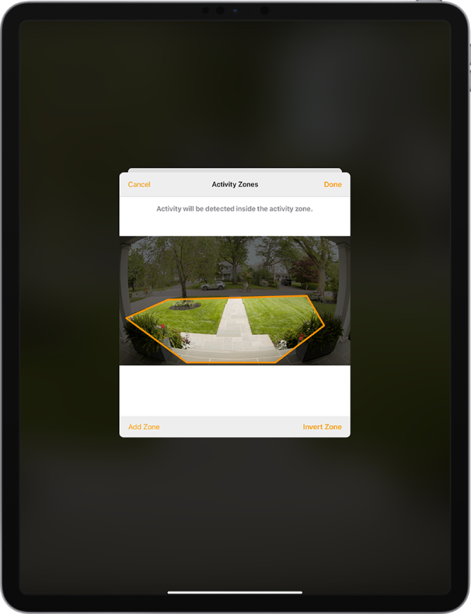 The iPad screen showing an activity zone within an image taken by a doorbell camera. The activity zone encompasses a front porch and walkway, but excludes the street and driveway. Cancel and Done buttons are above the image. Add Zone and Invert Zone buttons are below.