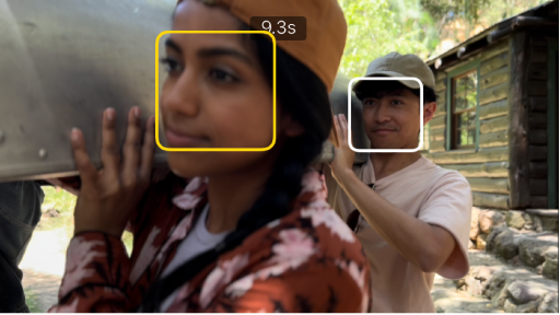 A Cinematic mode clip in the viewer, with a solid yellow box around a face indicating that the focus is locked on that object. A white box appears on an object not in focus.