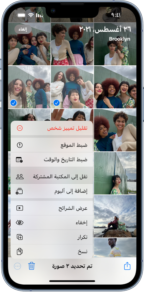 شبكة من الصور المصغرة تملأ الشاشة. تم تحديد صورتين مصغرتين وتفتح قائمة المزيد في أسفل الشاشة. تم تحديد خيار نقل إلى المكتبة المشتركة في القائمة.