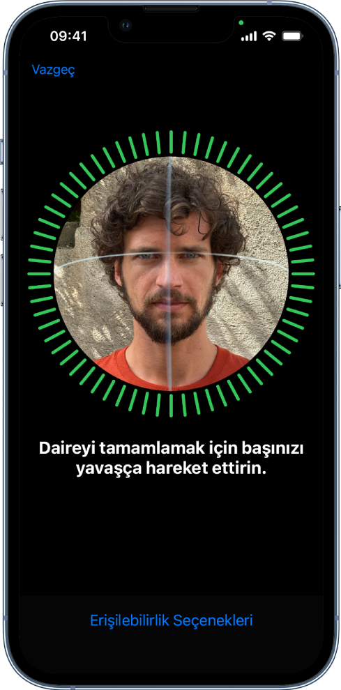 Face ID tanıma ayarlama ekranı. Ekranda, daire içine alınmış bir yüz gösteriliyor. Alt tarafta, kullanıcıya daireyi tamamlamak için kafasını yavaşça hareket ettirmesini söyleyen bir metin var. Ekranın alt tarafında Erişilebilirlik Seçenekleri düğmesi görünür.